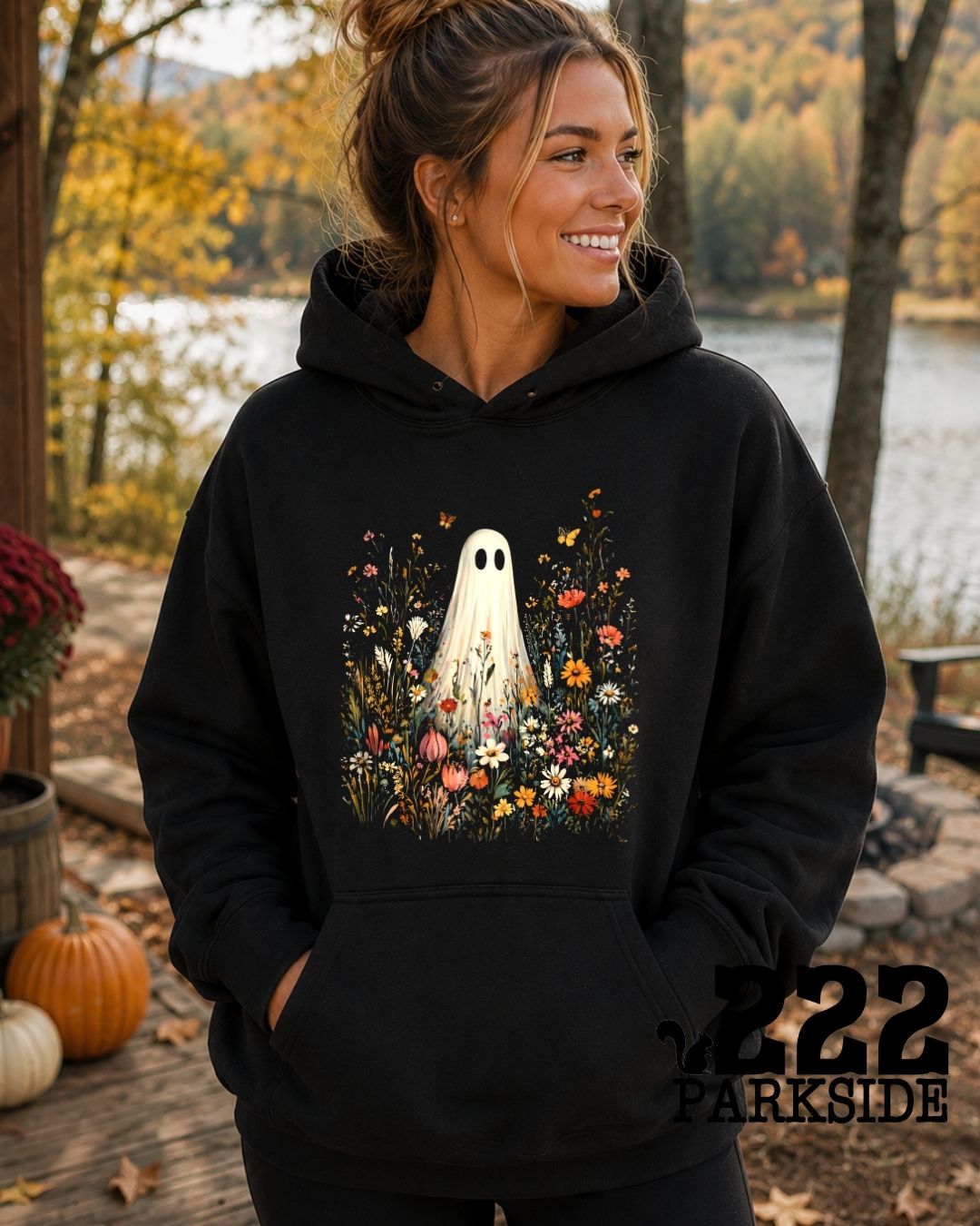 Ghost wildflower hoodie worn by a lake in fall foliage