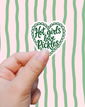 Hand holding a sticker with 'Hot girls love Pickles' text against a pink background with green stripes