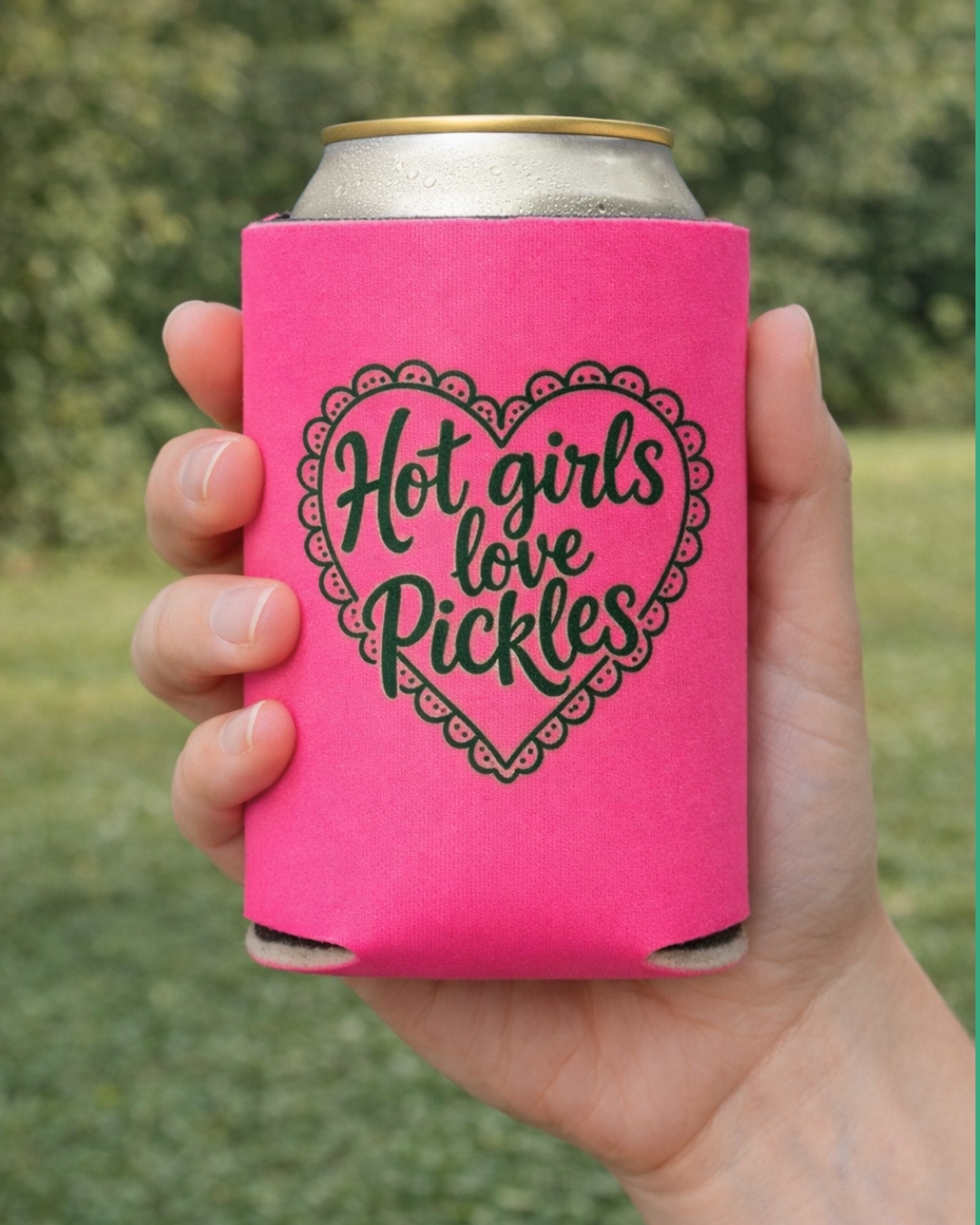 Hand holding a pink can cooler with 'Hot girls love Pickles' text.