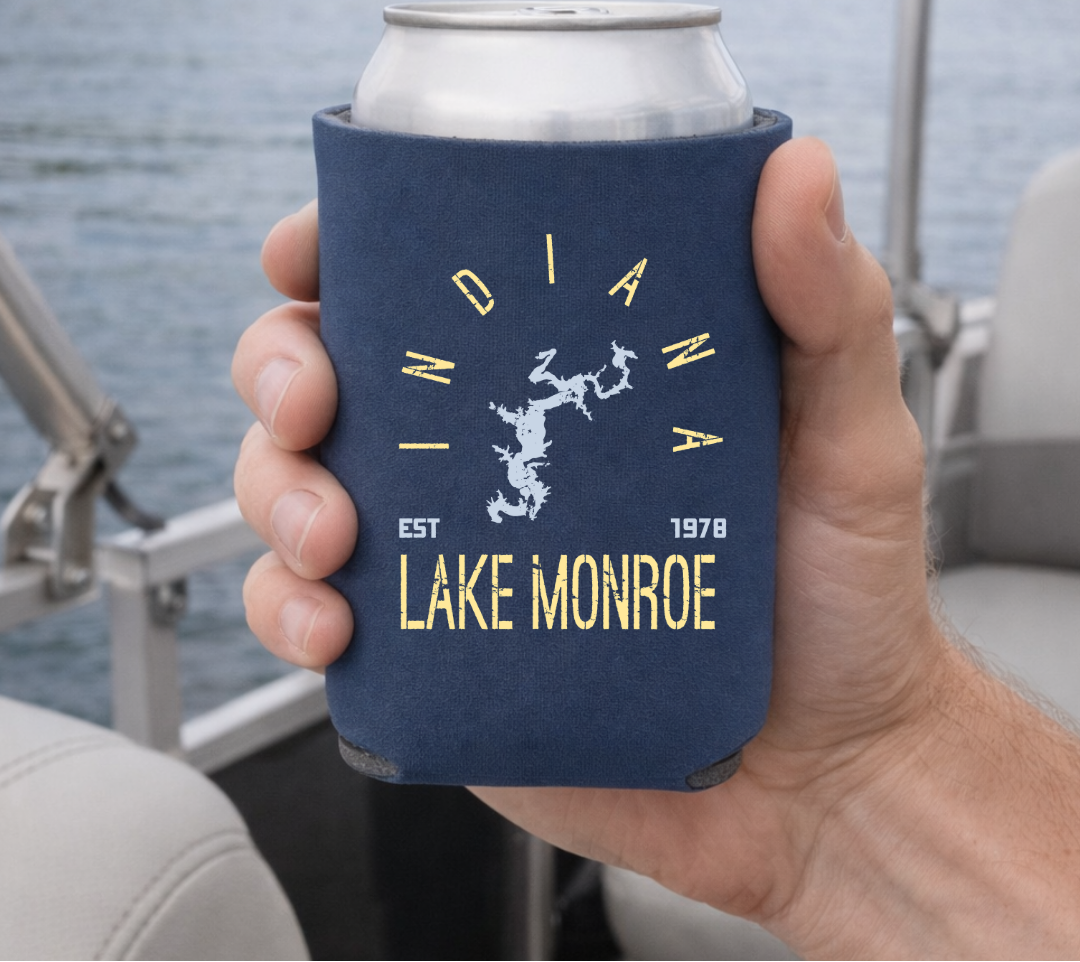 Hand holding a can cooler with 'Indiana Lake Monroe' text on a boat.