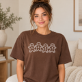 Woman wearing brown Comfort Colors gingerbread graphic tee