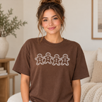 Woman wearing brown Comfort Colors gingerbread graphic tee