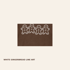 Close-up of white gingerbread friends graphic on Comfort Colors 1717 Espresso tee