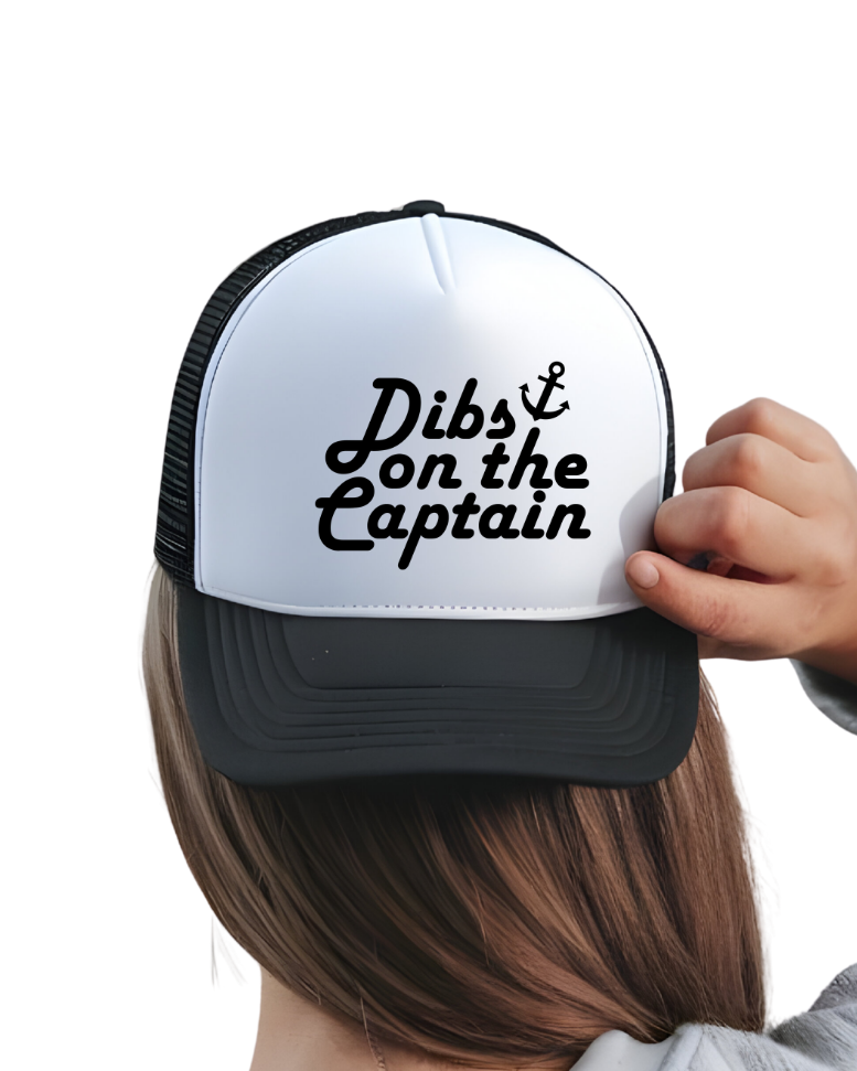 black and white trucker hat that says dibs on the captain in black text 
