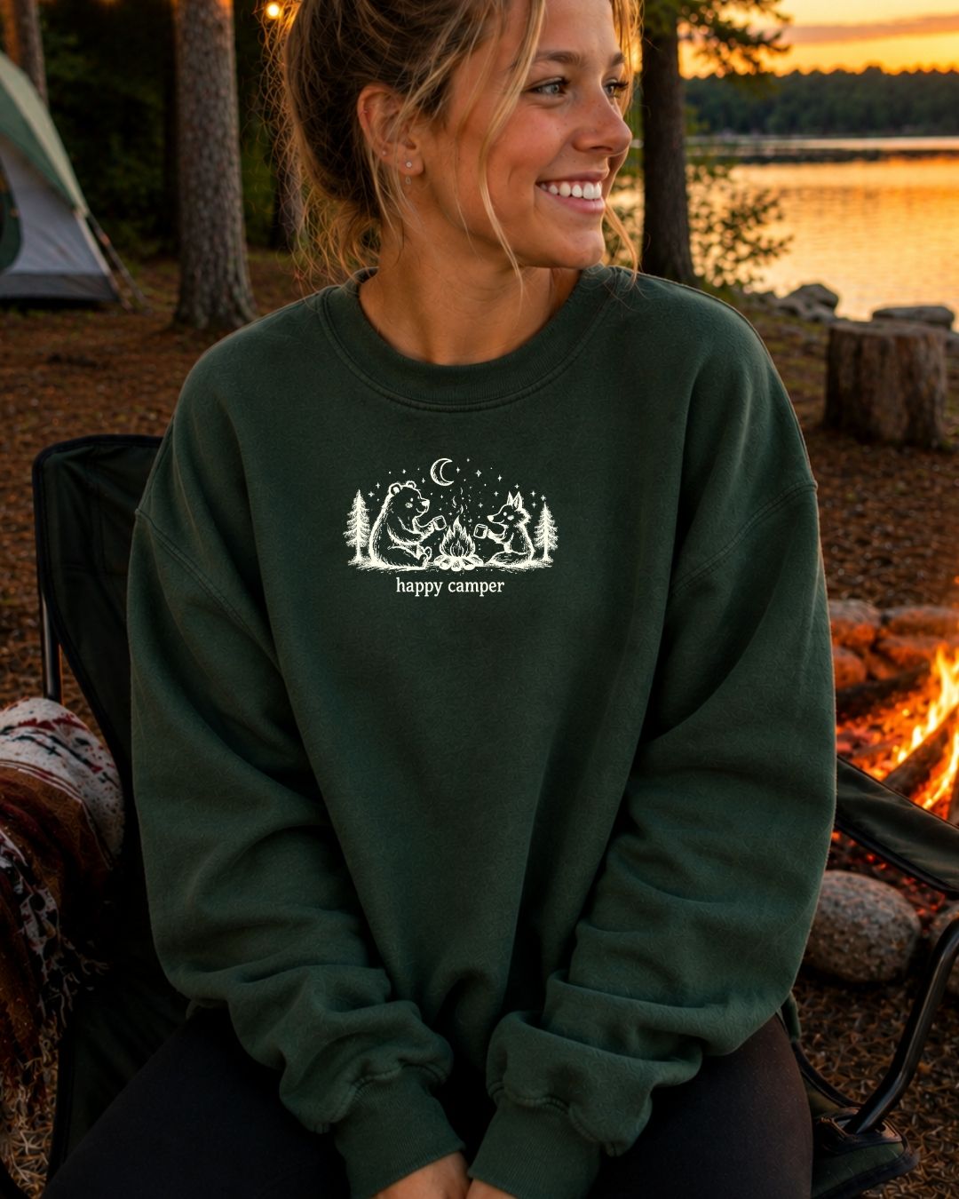 Happy Camper crewneck sweatshirt in Emerald by a campfire lakeside
