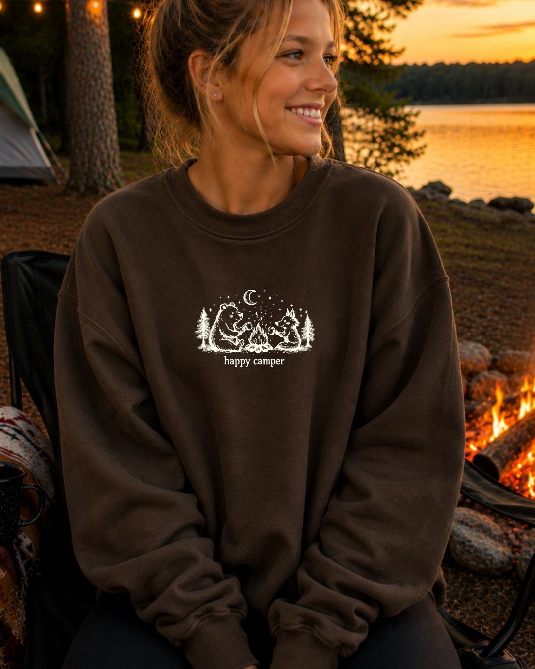 Happy Camper crewneck sweatshirt in Chocolate by a campfire lakeside