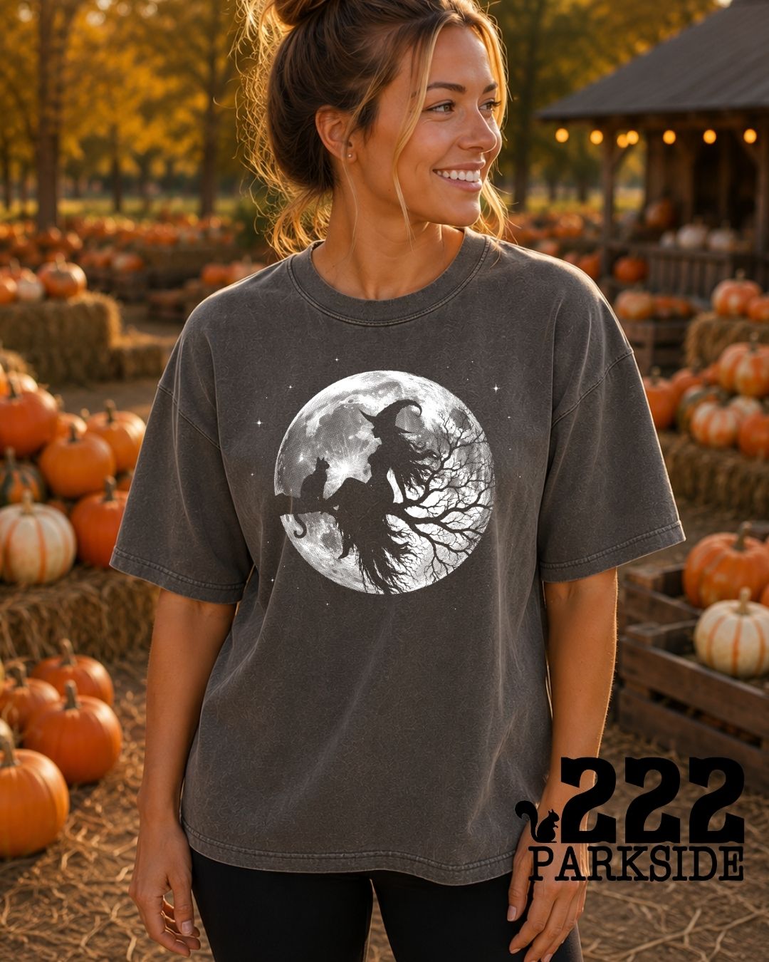 Midnight Ride witch and black cat moonlit graphic tee at a pumpkin patch